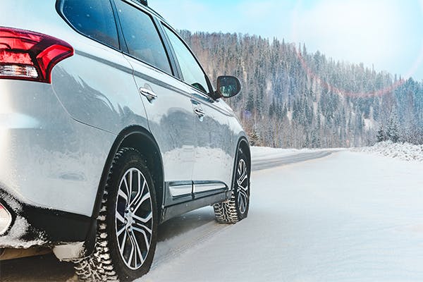 Modern-Suv-car-stay-on-roadside-of-winter-road.